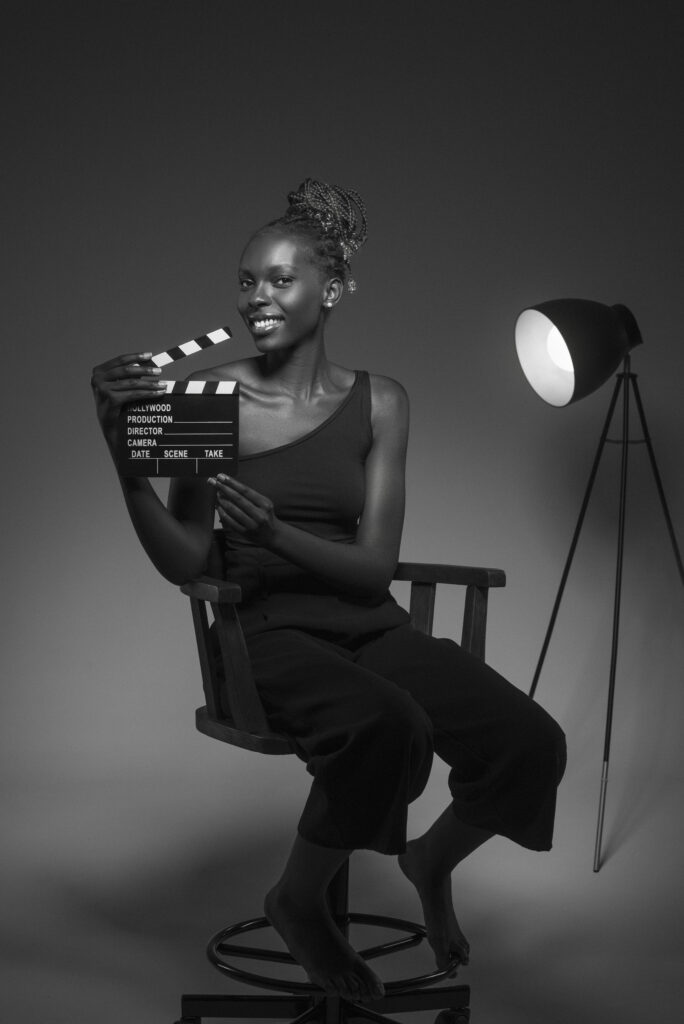 black white portrait woman with clapperboard old hollywood glamour style