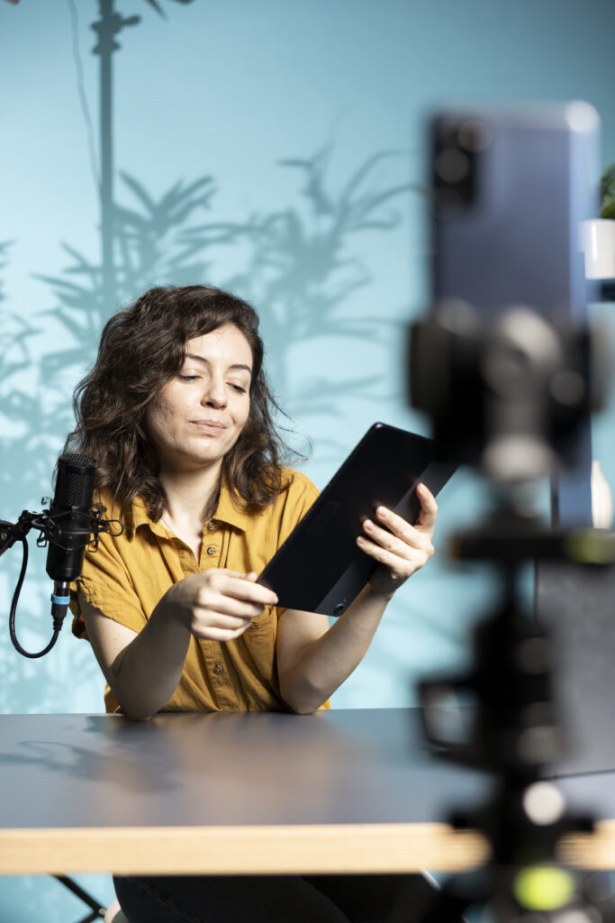 content creator analyzing newly released gaming tablet received from sponsor content creator analyzing newly released gaming tablet received from sponsor